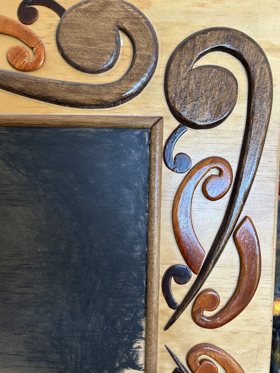 Carved koru frame detail — Artwork by Hiki Reedy